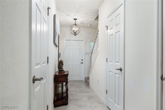 doorway to outside featuring a chandelier