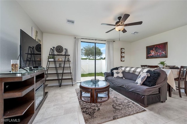 living room with ceiling fan and light tile patterned floors