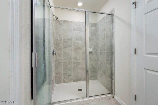 bathroom featuring a shower with shower door