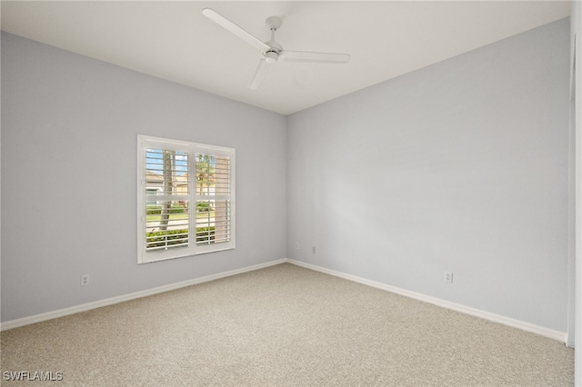 spare room featuring ceiling fan and carpet