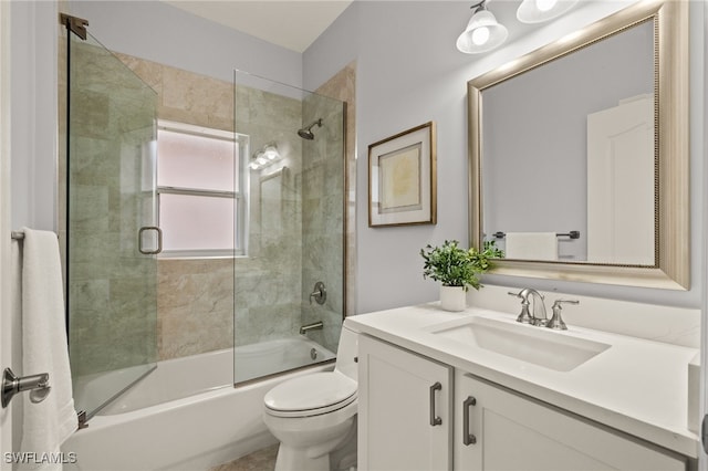 full bathroom featuring enclosed tub / shower combo, vanity, and toilet