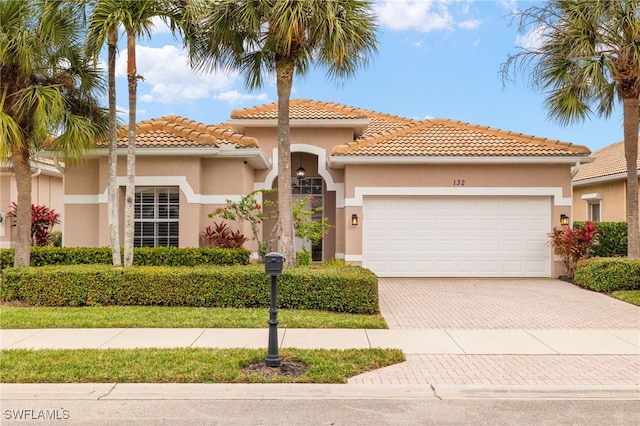 mediterranean / spanish-style house with a garage