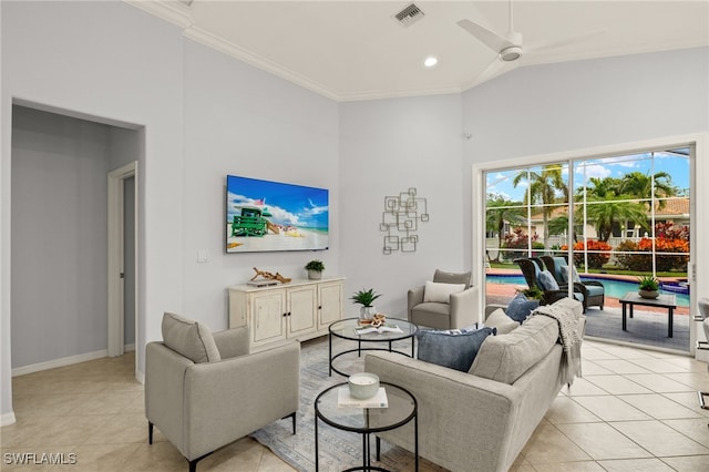 tiled living room with ceiling fan and crown molding