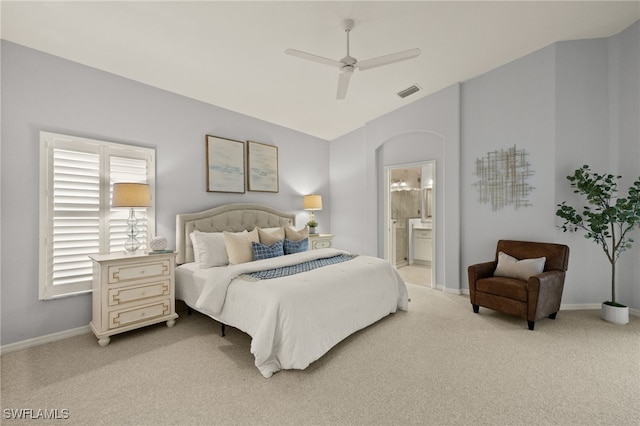 carpeted bedroom featuring ensuite bath, ceiling fan, and lofted ceiling