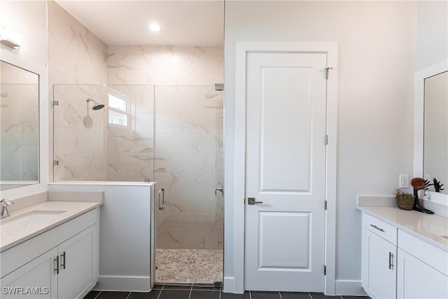 bathroom featuring walk in shower, vanity, and tile patterned floors