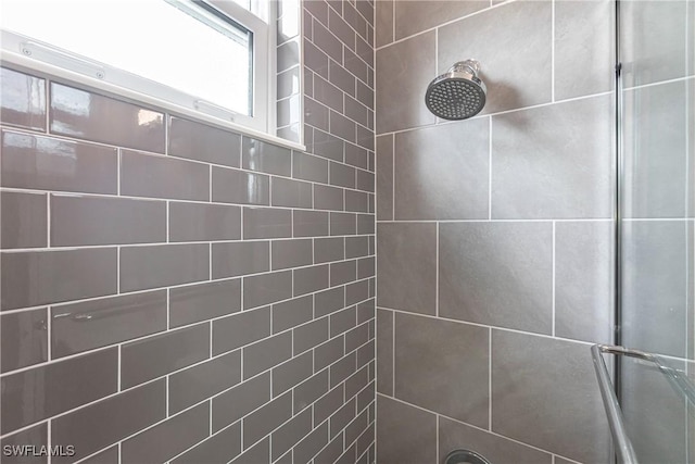 bathroom with tiled shower