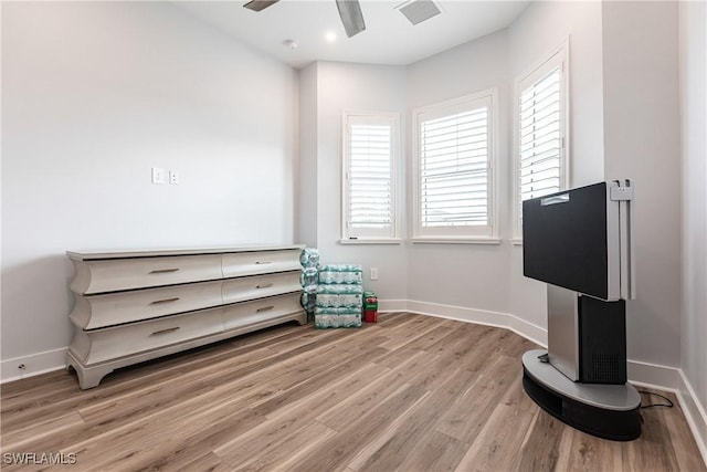 sitting room with ceiling fan and light hardwood / wood-style flooring