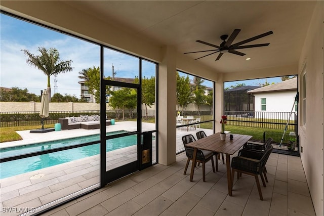 sunroom / solarium featuring ceiling fan