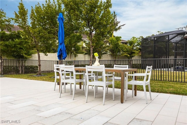 view of patio featuring glass enclosure