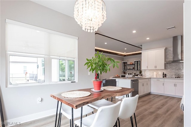 dining room featuring a notable chandelier and light wood-type flooring