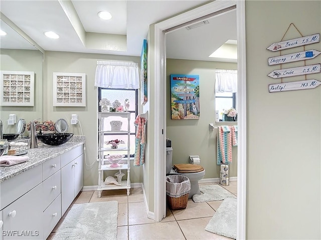 bathroom featuring toilet, vanity, and tile patterned floors