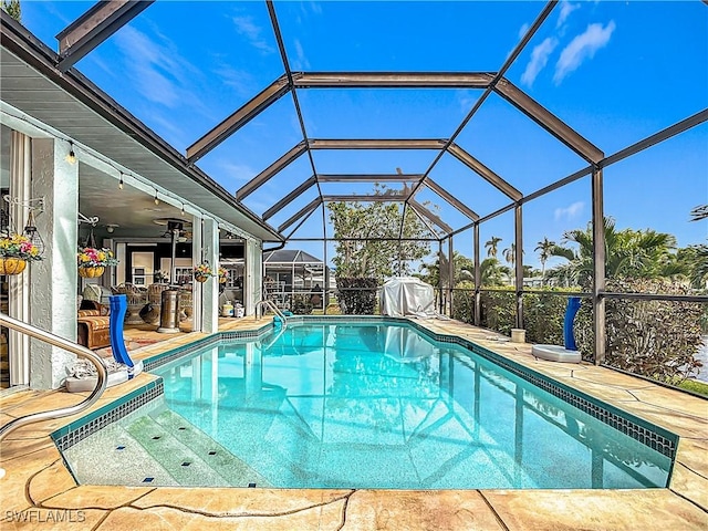 view of pool with a lanai, a patio area, and a bar