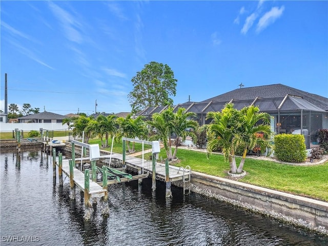 view of dock with a lanai, a water view, and a yard