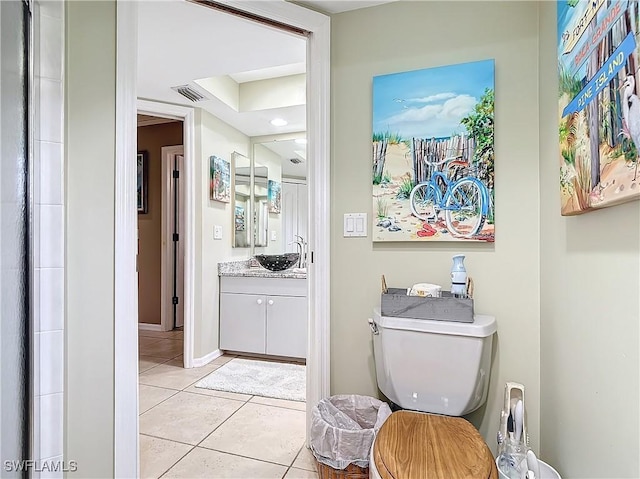 bathroom featuring toilet, tile patterned floors, and vanity