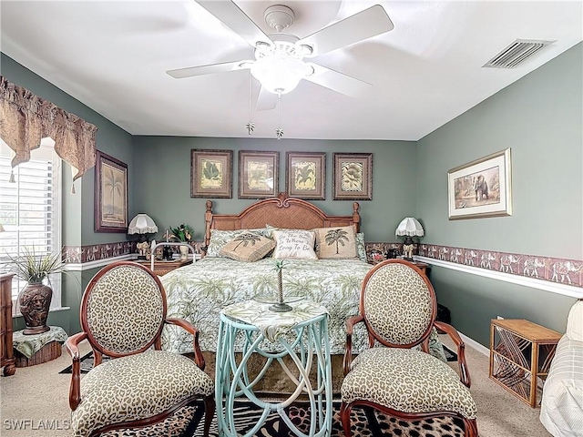 bedroom with ceiling fan and light carpet