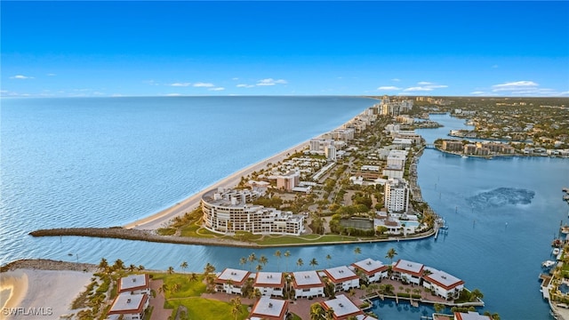 drone / aerial view with a water view and a beach view