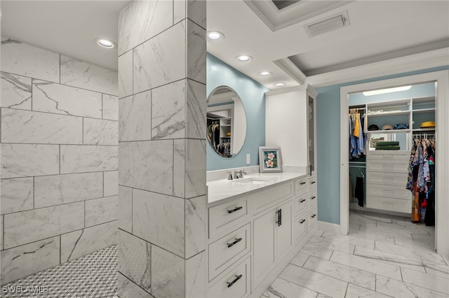 bathroom featuring walk in shower, ornamental molding, and vanity