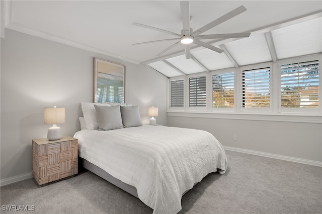 carpeted bedroom with ceiling fan and vaulted ceiling