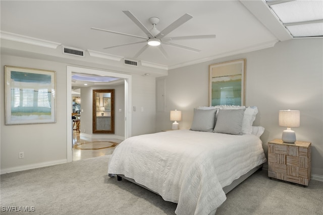 bedroom featuring ceiling fan, light colored carpet, and ornamental molding