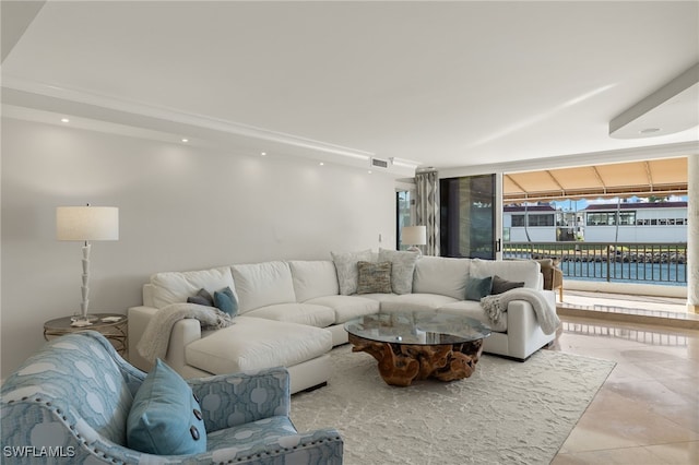 tiled living room featuring floor to ceiling windows