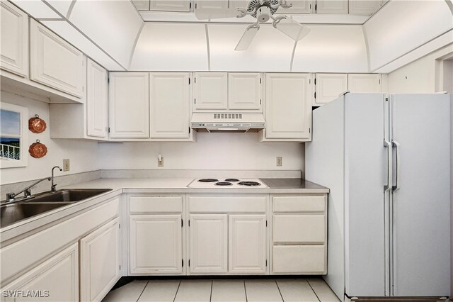 kitchen with premium range hood, white cabinetry, sink, and white appliances