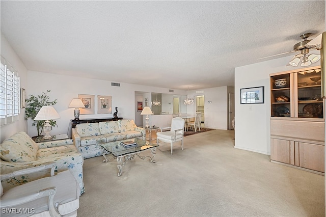 carpeted living room featuring a textured ceiling and ceiling fan