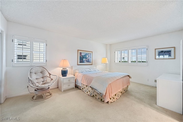 carpeted bedroom with a textured ceiling