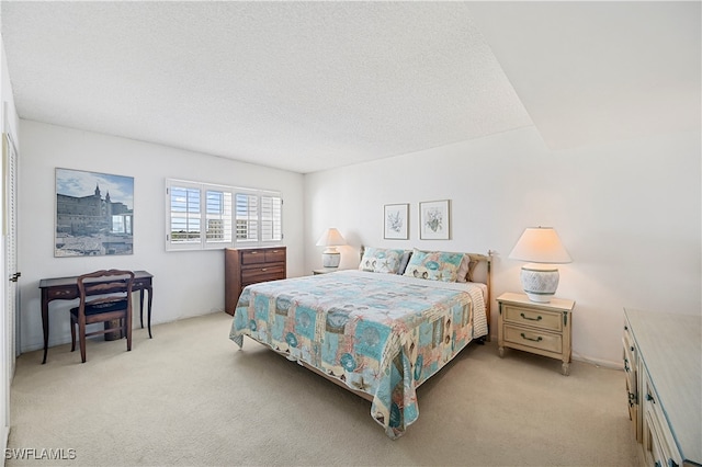 carpeted bedroom with a textured ceiling