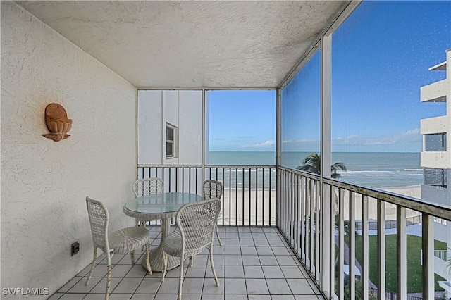 unfurnished sunroom featuring a water view