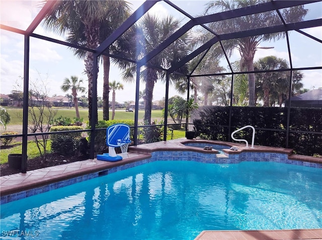 view of swimming pool with glass enclosure and an in ground hot tub