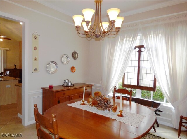 tiled dining space featuring a notable chandelier and crown molding