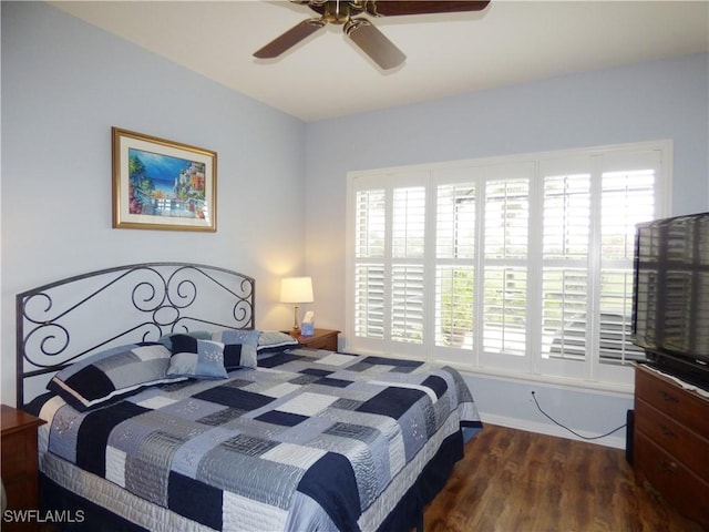 bedroom with ceiling fan, multiple windows, and hardwood / wood-style flooring