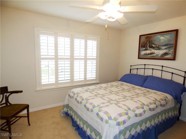 bedroom featuring ceiling fan and light colored carpet