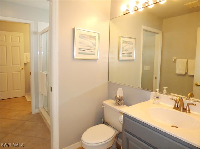 bathroom with toilet, vanity, tile patterned flooring, and an enclosed shower