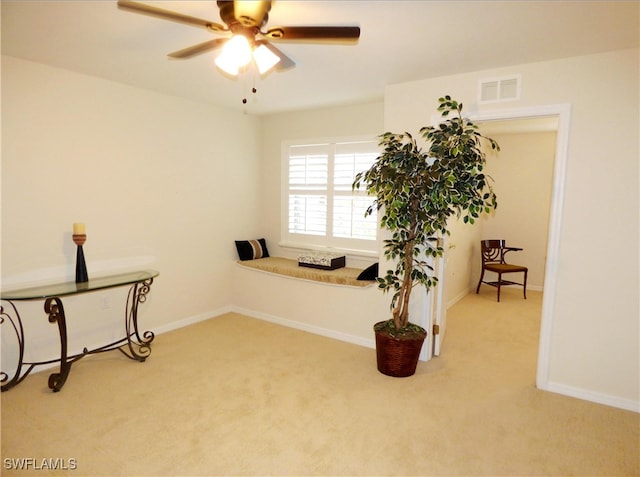 interior space with carpet floors and ceiling fan