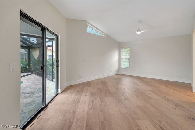 unfurnished room with light hardwood / wood-style floors, ceiling fan, and vaulted ceiling