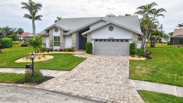 single story home featuring a front lawn and a garage