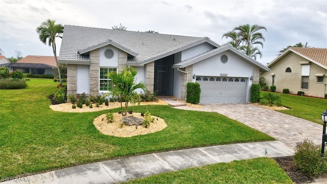 ranch-style home with a garage and a front yard