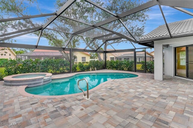 view of pool with glass enclosure, an in ground hot tub, and a patio