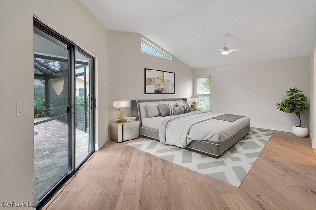 bedroom featuring a ceiling fan, wood finished floors, baseboards, access to exterior, and vaulted ceiling