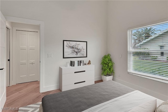 bedroom featuring light wood-type flooring and baseboards
