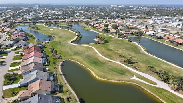 bird's eye view with golf course view, a water view, and a residential view
