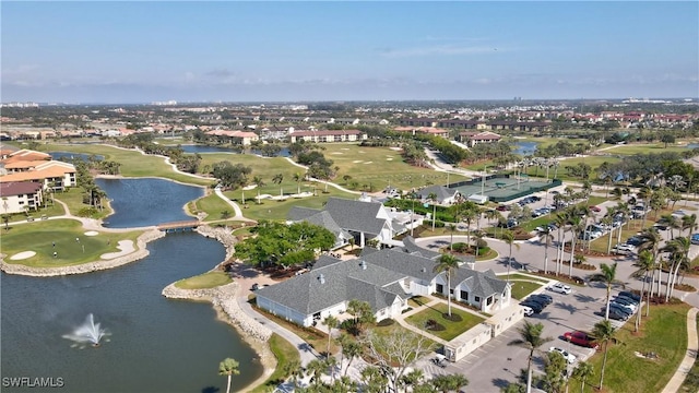 drone / aerial view with golf course view, a water view, and a residential view