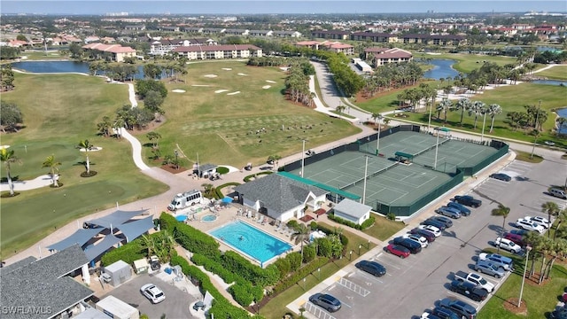 bird's eye view featuring golf course view and a water view