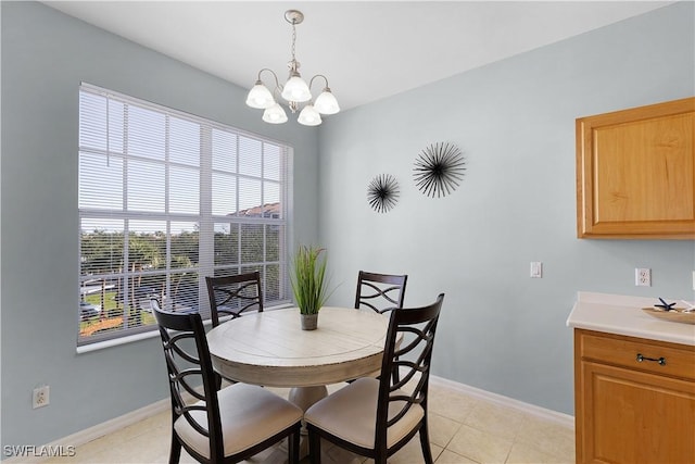 tiled dining space featuring a notable chandelier