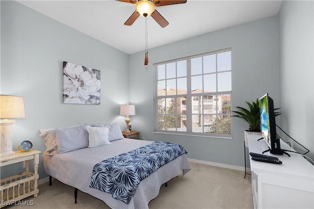 bedroom with ceiling fan and light colored carpet