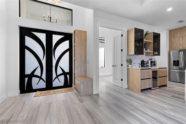 entryway featuring wine cooler and french doors