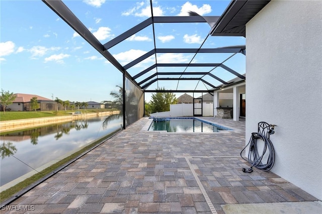 view of swimming pool with a water view, a lanai, and a patio area