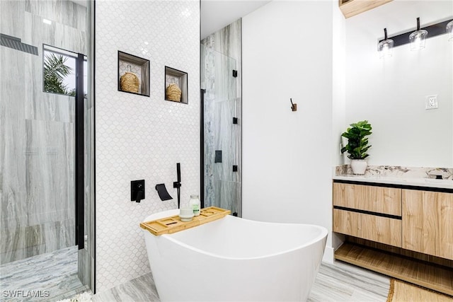 bathroom with vanity and separate shower and tub