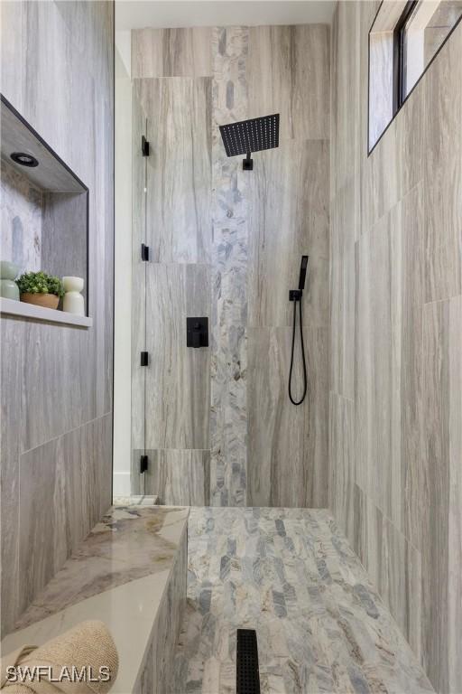 bathroom with tiled shower